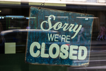 Sign on the shop door with the inscription: Sorry, we are closed