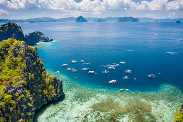 Miniloc island, Palawan, Philippines. Aerial view of tourism day trip boats on island hopping tour at big lagoon entrance