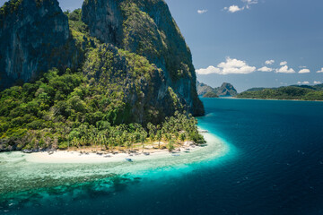 Unique beauty of tropical Pinagbuyutan Island and white sand ipil beach in blue ocean El Nido, Palawan, Philippines. Aerial view