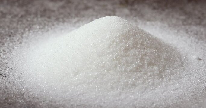Panning Over a White Granulated Sugar Pile on a Grey Background