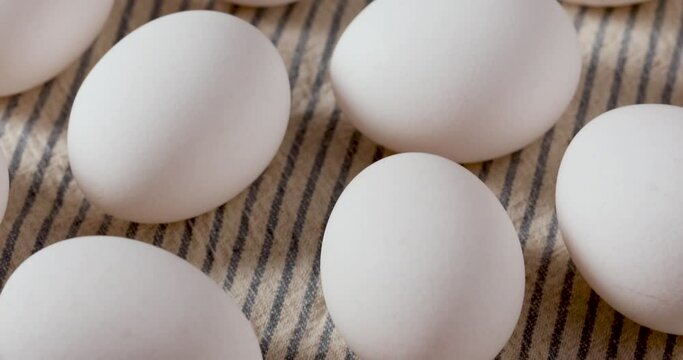 Tilting Up Over Organic Raw White Eggs in a Bunch