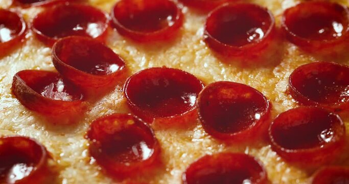 Hand Held Closeup Shot of Pepperoni Pizza with Mozzarella Cheese