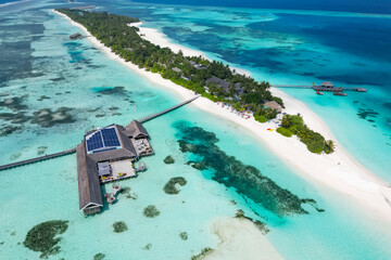 stunning blue ocean and sandy lux hotels on water top drone aeral view Maldives beach copyspace for...