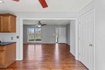 interior of simple ranch style home in the country with original oak hardwood floors, gray walls and white trim. Empty home. Stage with any furniture you would like. 