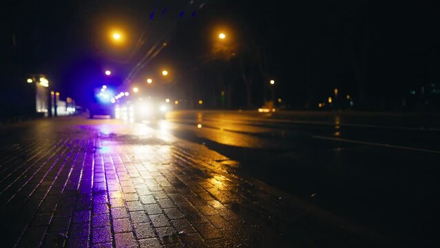 Defocused background footage: Emergency light in wet city streets