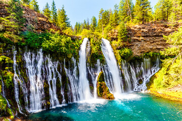 Fototapeta na wymiar Waterfall in the forest with lake, trees