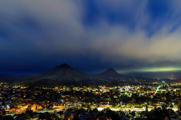Mountain and city lights at night, clouds, 