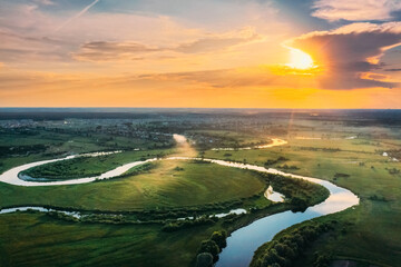 Aerial View. Beautiful Sunset Sun Sunshine Above Green Forest, Meadow And River Landscape In Sunny...