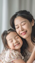 Asian mother hugging her child on background