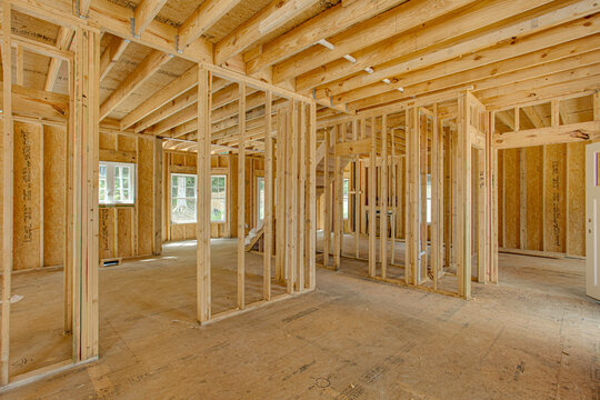 Home Under Construction with Wooden Framing, Exposed Beams and Framework