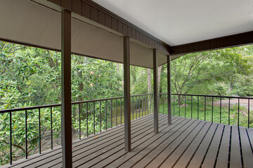 Fototapeta premium Comfortable Covered Screened Porch Overlooking Dense Greenery, Tranquil Outdoor Experience in Summer