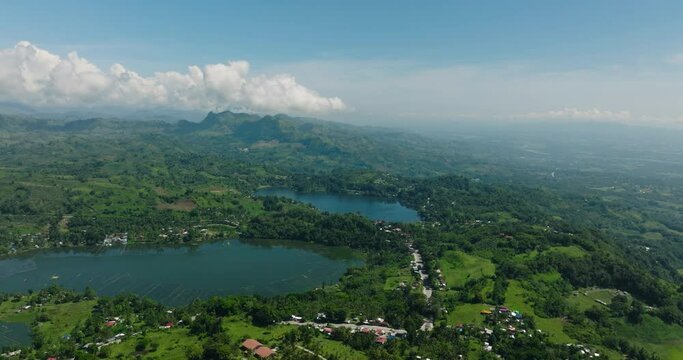 Drone view of Lake Sebu and Lake Lahit surrounded by mountains with green forest and farmland. Mindanao, Philippines.