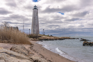 Spring photo of Five Mile Point Lighthouse AKA Old New Haven Harbor Lighthouse, in New Haven, CT, on a cloudy day.
