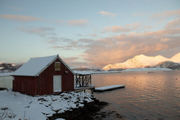 Cabin by the lake in wintertime.