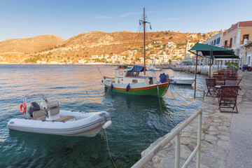 Fishing boats in the village of Symi at sunset. - 784141153
