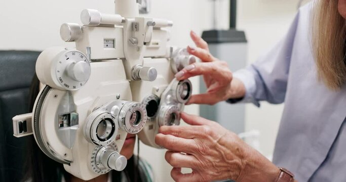 Eye care, medical and child in clinic, test and hand of specialist, phoropter or refractor for girl. Healthcare, technology and machine for help for kid, exam and vision for check up in hospital