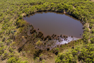 Drone's gaze captures rural Victoria's farm dam: a serene tableau of nature's simplicity, where still waters mirror the tranquil essence of the countryside.