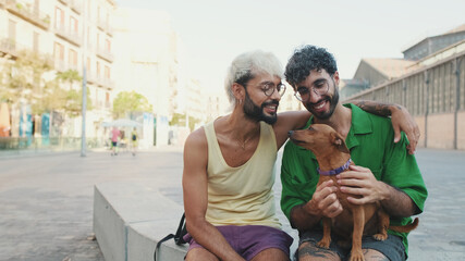 Gay couple spend time together with their dog outdoors