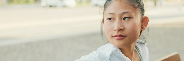 Young woman resting on bench on the street of the old city, Panorama
