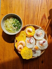 Banh can - The mini pancakes with rice flour, egg, onion leaves with soft selective focus, and blurred background. Banh can is a portion of Vietnamese street food. Food photography.
Photo Formats

299