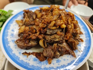 Fried muscovy duck meat with garlic, a famous dish in Hanoi, Vietnam