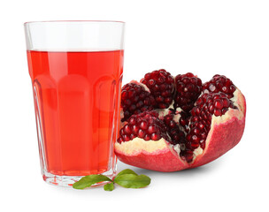 Refreshing pomegranate juice in glass, leaves and fruit isolated on white