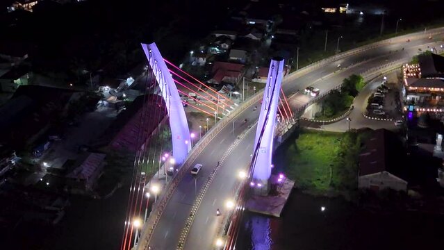 View of the Banjarmasin city and Alalak River Bridge or Basit Bridge from a drone during the night