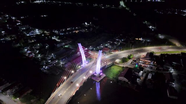 View of the Banjarmasin city and Alalak River Bridge or Basit Bridge from a drone during the night