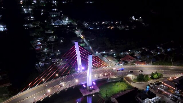 View of the Banjarmasin city and Alalak River Bridge or Basit Bridge from a drone during the night