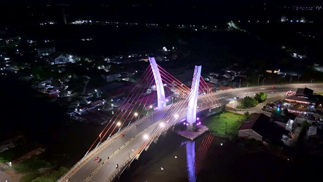 View of the Banjarmasin city and Alalak River Bridge or Basit Bridge from a drone during the night