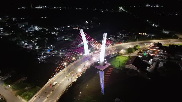 View of the Banjarmasin city and Alalak River Bridge or Basit Bridge from a drone during the night