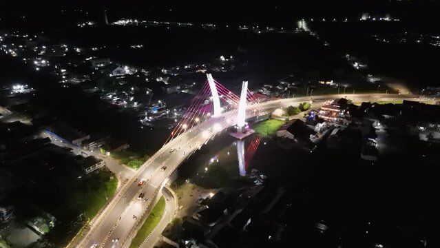 View of the Banjarmasin city and Alalak River Bridge or Basit Bridge from a drone during the night