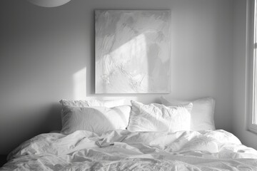 Sunlit bedroom with an unmade bed and white textured artwork on the wall.