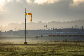 Yellow wind sock blows at airport