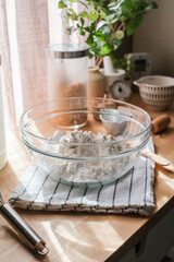 The composition of flour in the glass bowl for baking concept. vertical.
