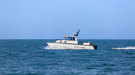 A Coast Guard boat sailing along the coastline