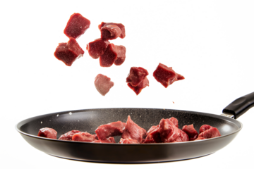 Pieces of meat flying in a frying pan on a transparent background