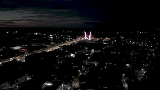 View of the Banjarmasin city and Alalak River Bridge or Basit Bridge from a drone during the night