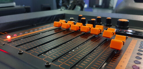 Close up orange button of sound mixer panel equipment for mixing or control audio system with...