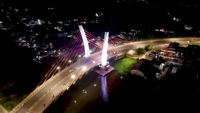 View of the Banjarmasin city and Alalak River Bridge or Basit Bridge from a drone during the night