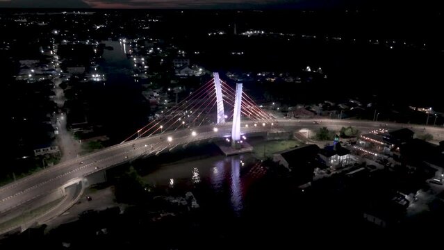 View of the Banjarmasin city and Alalak River Bridge or Basit Bridge from a drone during the night