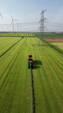 John Deere tractor with trailer on harvest. John Deere tractor with harvester, Netherlands