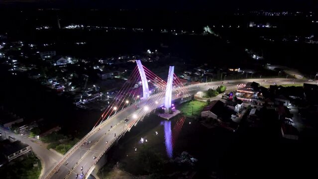 View of the Banjarmasin city and Alalak River Bridge or Basit Bridge from a drone during the night