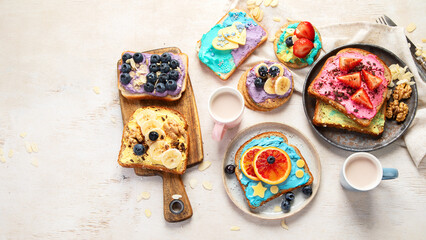 Sweet breakfast with cup of cocoa. Toast with cream cheese, banana, strawberries, blueberries
