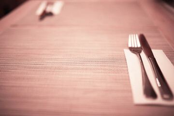 cutlery on the table in a restaurant table setting, knife, fork, spoon, interior