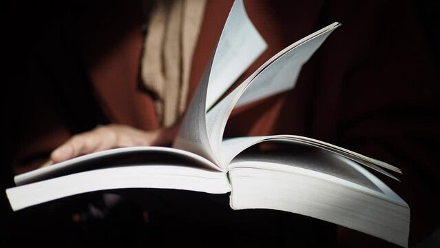women hand holding a book at library 