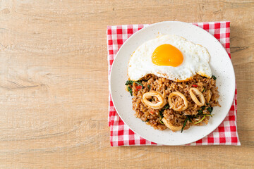 fried rice with squid and basil topped fried egg in Thai style