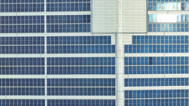The rooftop is a quilt of sky-blue solar panels, silently harvesting clean energy, a beacon of environmental stewardship. Solar panels background. 4K.
