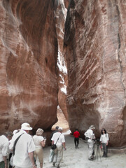 Tourists view sights along Al Siq gorge of Petra Historical Reserve in the Wadi Musa city in Jordan
