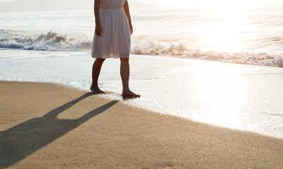 Woman legs walking on beach. - Powered by Adobe